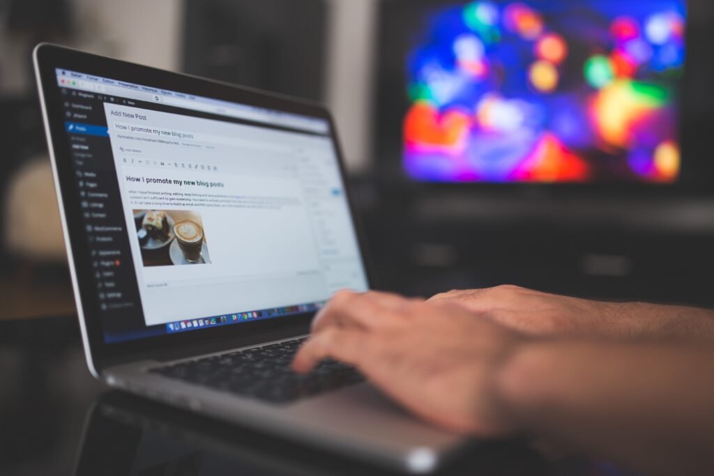Hands typing a blog post on a laptop for guest posting