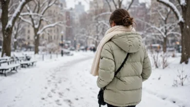 Woman wearing a warm winter jacket in a snowy park