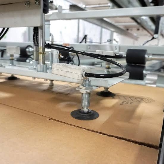 Bestpack packaging systems case sealer with conveyor belts and taping head in a packaging line