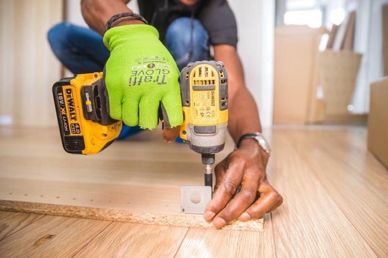 Cordless drill in use during Chamberlain garage door opener repair work